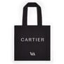 A black tote bag with the name CARTIER in centre and V&A logo at the bottom.