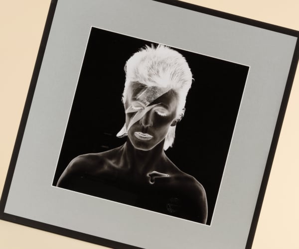 An artistic negative photo portrait of David Bowie