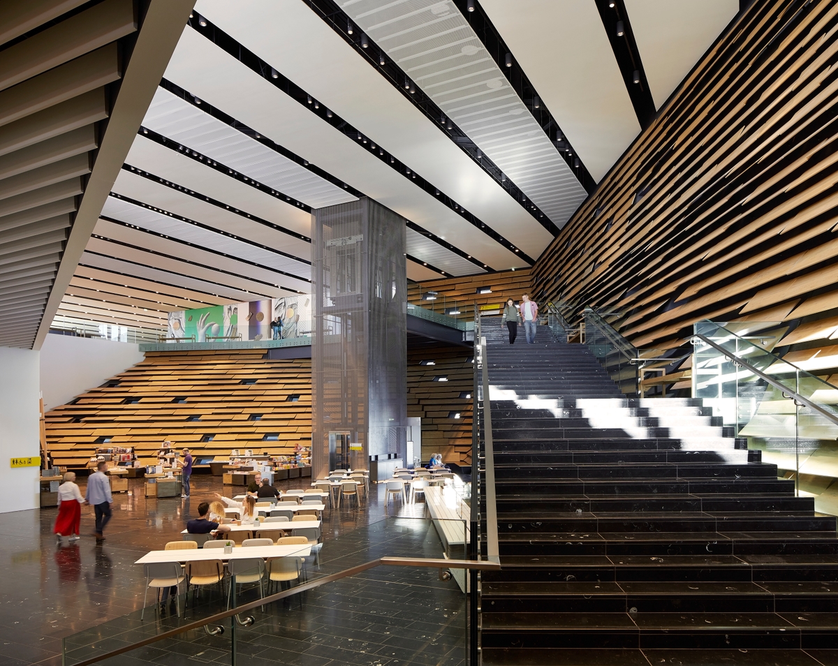 An interior shot of V&A Dundee, people are walking down the stairs